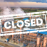 Industrial plant from above with a large 'CLOSED' stamp across the image, indicating the facility is shut down.